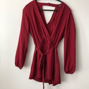Red long sleeved romper with waist tie